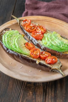 Baked eggplant with cheese, avocado and tomatoes