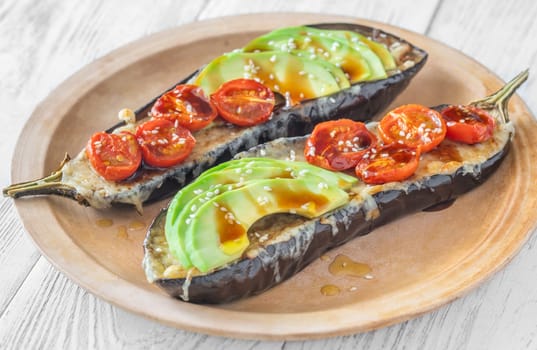 Baked eggplant with cheese, avocado and tomatoes