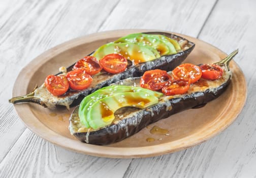 Baked eggplant with cheese, avocado and tomatoes