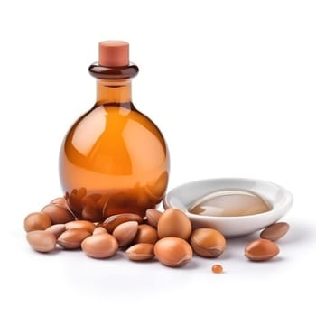 A bottle of argan oil surrounded by argan nuts, depicting the source and final product together.