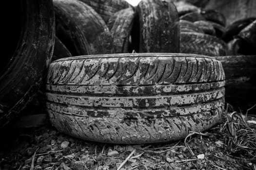 Detail of old damaged and worn car tire, recycling