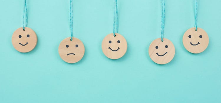 Happy smiling face spread happiness to sad faces, newton cradle concept, mental health and attitude, positive and negative mind, influence emotion, support and depression, pendulum balls