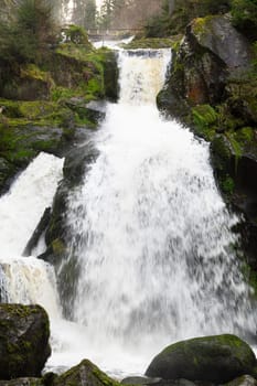 Triberg waterfall in the Black Forest, highest fall in Germany, Gutach river plunges over seven major steps into the valley, wooden bridge