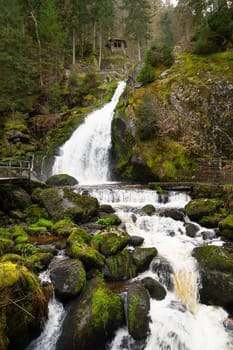 Triberg waterfall in the Black Forest, highest fall in Germany, Gutach river plunges over seven major steps into the valley, wooden bridge
