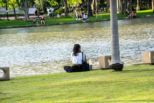 Woman sitting in the park. The park is a place to relax, talk, for everyone.