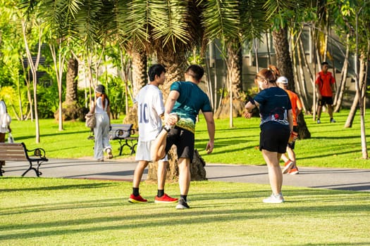 People warming up before running in the park.
