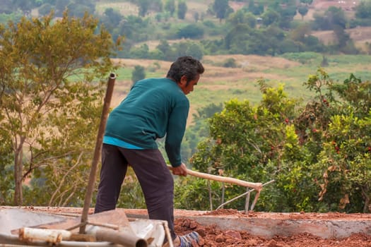 Construction worker are digging the ground to make walkways and walls.