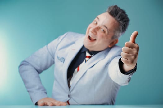 Joyful businessman gives a thumbs up, his face radiating enthusiasm and positivity in a professional setting