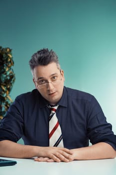 Thoughtful man in glasses judges quietly, convinced he must correct every error as he listens to explanations