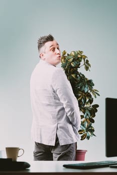 Man in light suit jacket, facing away, urinates in a plant pot, symbolizing abuse of privilege in a dominant position, knowing the context won't punish such blatantly wrong acts