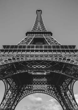 Looking up at the Eiffel Tower in Paris, France done in black and white.