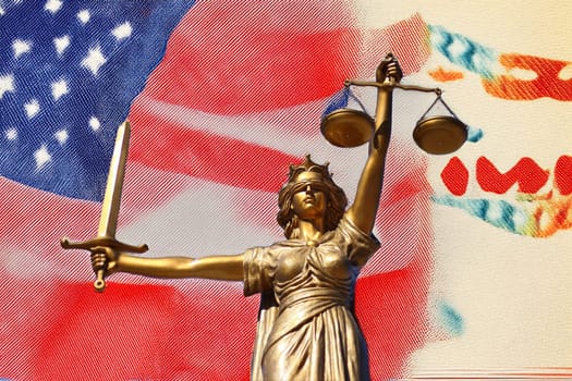 The Statue of Justice, Goddess of Justice in front of the USA flag.