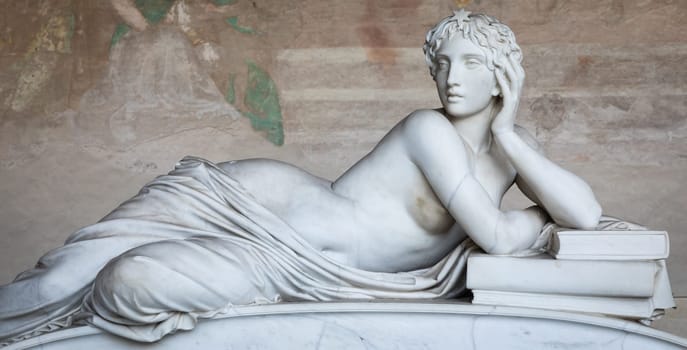 Pisa, Italy - 29 June 2023: sad statue in cemetery. Vintage white marble sculpture, woman sorrow