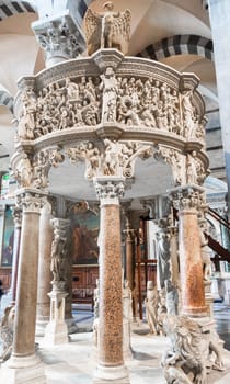 Pisa, Italy - 29 June 2023. Cathedral interior. The pulpit, Medieval art masterpiece by sculptor Giovanni Pisano, 1310