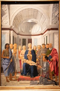 Milan, Italy - 23 September 2023: Brera antique painting museum. Madonna and child with saints, angels and Federico da Montefeltro, by painter Piero della Francesca, 1470