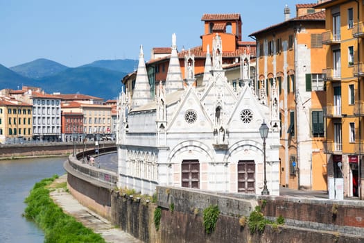 Pisa, Italy - 29 June 2023: colourful buildings on Arno river. Urban skyline, travel destination.