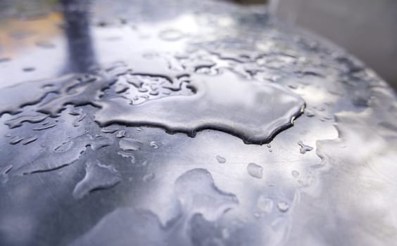 Detail of wet steel surface with rain drops