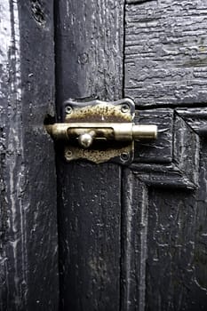 Detail of security lock on an old wooden door