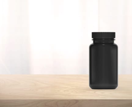 Black supplement bottle for medicine on wooden table