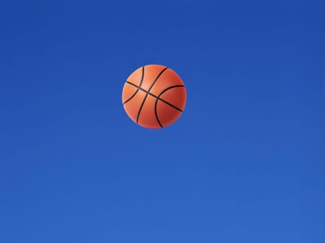 A basketball shot in the air with blue sky background