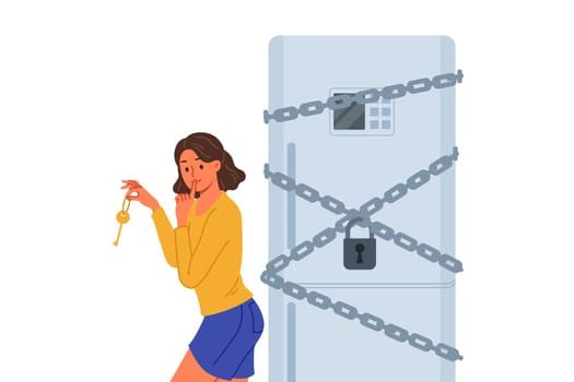 Woman starting diet locked refrigerator to reduce number of calories from food consumed. Funny girl wants to break diet and have dinner at night, due to lack of willpower and motivation