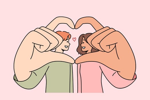 Romantic couple shows symbol of love and devotion, giving heart from hands and wanting to kiss. Multinational man and woman are proud of mutual love or opportunity to build united family