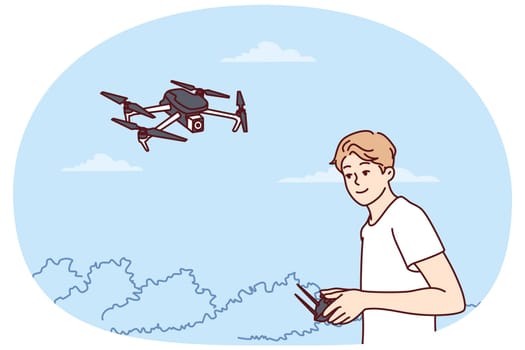 Teenage boy launches quadcopter using remote control and makes aerial photography from drone. Guy has hobby launching miniature aircraft or quadcopter with remote operation wanting to become operator