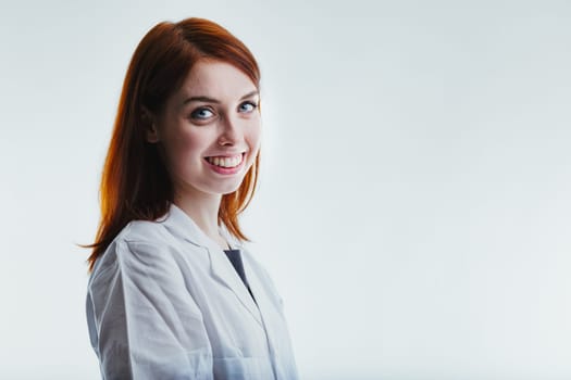 smiling red-haired woman in a lab coat highlights her role as an accomplished technology expert and researcher, with multiple doctorates underscoring her academic and professional excellence