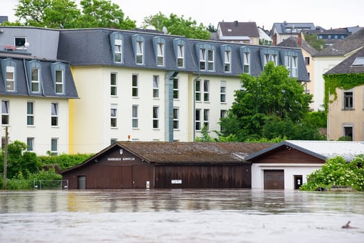 Flood of the river Saar, Saarburg in Saarland, Germany, flooded trees and paths, high water level, climate change