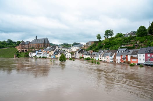 Flood of the river Saar, Saarburg in Saarland, Germany, flooded trees and paths, high water level, climate change