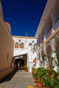 SYMI, Greece - JUN 03, 2021. SYMI, Greece - JUN 03, 2021. Panormitis Monastery of Archangel Michael in the southwest of the island of Symi is an important orthodox pilgrimage site and an important tourist attraction.