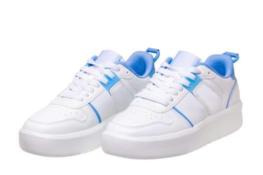 White sneaker isolated. Close-up of a pair white elegant stylish female leather high-heeled sport shoes isolated. Clipping path. Womens shoe fashion. Modern design footwear for workout.