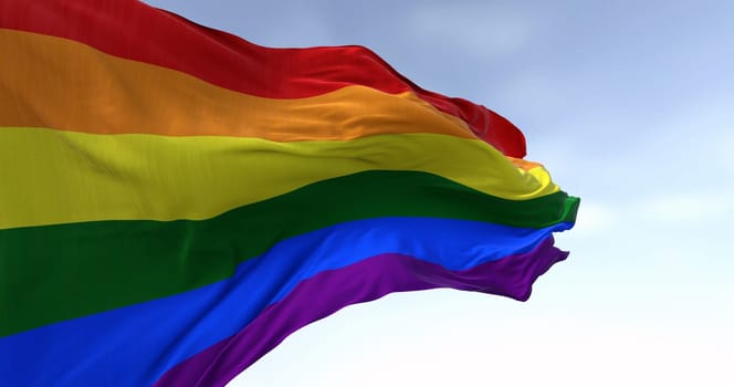 Rainbow flag waving on a clear day. Multicolored flag with stripes in the colors of the rainbow, often used as a symbol of LGBT pride. 3d illustration render. Fluttering fabric