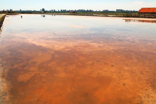 Visible orange and pink salt deposits in a pool of the Burgas Salt Pans, Lake Atanasovsko, Atanasovo, Burgas, Bourgas, Bulgaria 2022