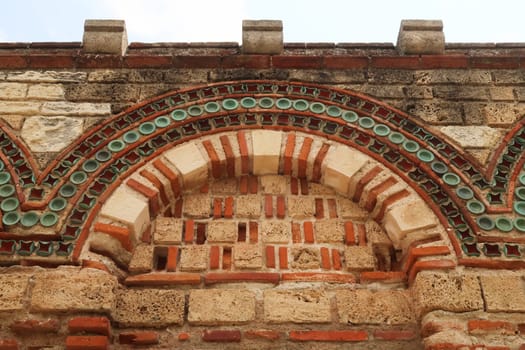 Elaborate patterns out of bricks and tiles decorate the facade of the Church of the Holy Archangels Michael and Gabriel in the old town of Nessebar, Nesebar, Bulgaria 2022