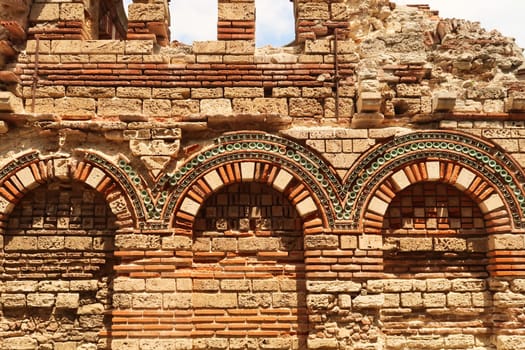 The elaborate facade of the Church of the Holy Archangels Michael and Gabriel in the old town of Nessebar, colorful patterns out of bricks and tiles, Nessebar, Nesebar, Bulgaria 2022