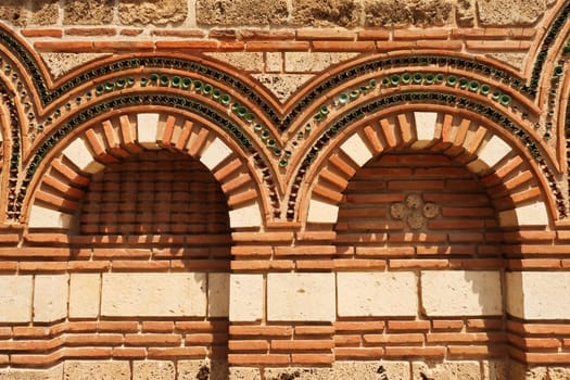 Patterns out of bricks and tiles decorate the elaborate facade of the Church of St., Saint Paraskevi, Sveta Paraskeva in the old town of Nessebar, Nesebar, Bulgaria 2022