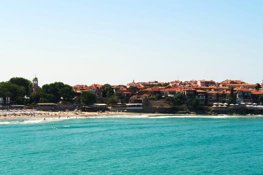 The old town of Sozopol, Sosopol next to the Sozopol Central Beach, intense blue turquoise water in the foreground, Bulgaria 2022
