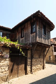 A traditional wooden house in a cobble stone street in the old town of Nessebar, Nesebar, Bulgaria 2022