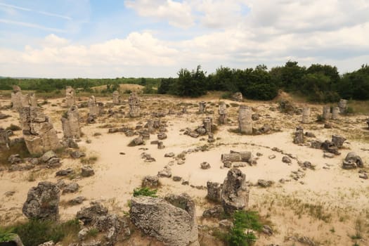View over the stone forest of Pobiti Kamani, a stone circle between many stone pillars rising from a desert-like landscape near Varna, Bulgaria 2022