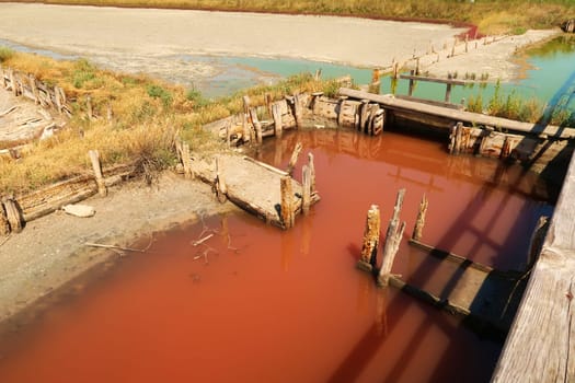 Board walks running through the different pools of the Burgas Salt Pans, filled with pink and green, turquoise salty water, Lake Atanasovsko, Atanasovo, Burgas, Bourgas, Bulgaria 2022