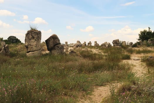 Walking through the Pobiti Kamani Stone Forest, one of the stone pillars has the shape of a head, face, near Varna, Bulgaria 2022