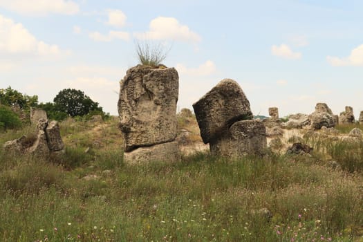 Two of the stone pillars at the Pobiti Kamani Stone Forest, one of them in the shape of a head, face, near Varna, Bulgaria 2022