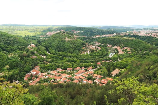 Spectacular view from the hiking trail along the Garga Bair Hill over the city of Veliko Tarnovo and the dense, lush forest that surrounds it, Veliko Tarnovo, Bulgaria 2022