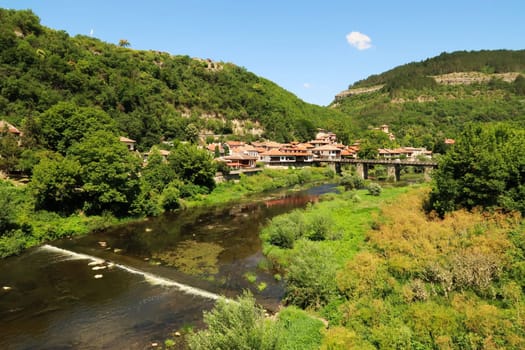 Scenic view from the Tsar Boris III Bridge onto Vladishki bridge, a wooden pedestrian bridge over the Yantra River, Veliko Tarnovo, Bulgaria 2022