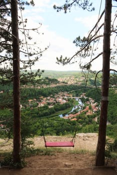 The love swing on Garga Bair offers a scenic view over the city of Veliko Tarnovo and the lush dense forest that surrounds it, Veliko Tarnovo, Bulgaria 2022