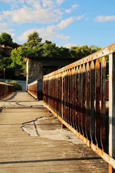 Rusted, rusty railing, handrail, rail on old concrete with potholes at an abandoned dam on the Yantra River in Veliko Tarnovo, Bulgaria 2022