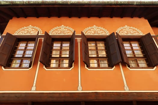 Row of windows on the facade of the Balabanov House, an example of National Revival Architecture in the old town of Plovdiv, Plowdiw, Bulgaria 2022