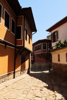 Beautiful cobble stone street between traditional houses in the old town of Plovdiv, Plowdiw, Bulgaria 2022