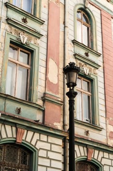 Black metal street lamp, lantern in front of the facade of the former Bulgarian National Bank building in the old town of Plovdiv, Plowdiw, Bulgaria 2022